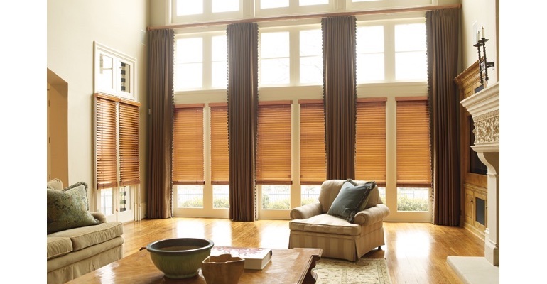 San Jose great room with wooden blinds and full-length drapes.